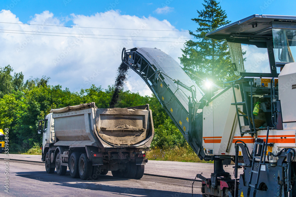 Heavy special machines. Asphalt heavy machinery in operation. Side view. Closeup.