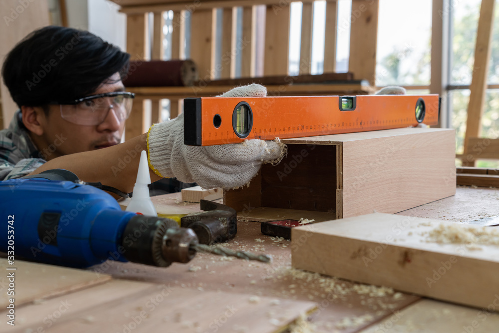 Carpenter working on wood craft at workshop