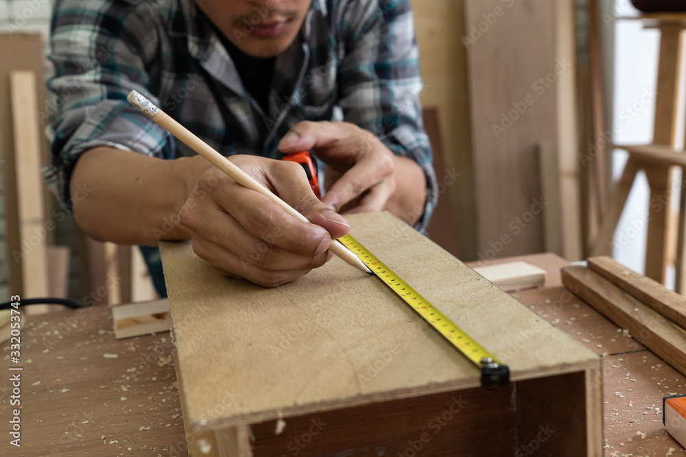 Carpenter working on wood craft at workshop