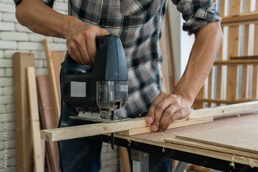 Carpenter working on wood craft at workshop