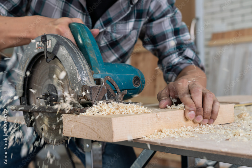 Carpenter working on wood craft at workshop