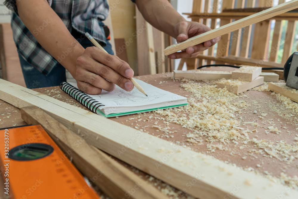 Carpenter working on wood craft at workshop