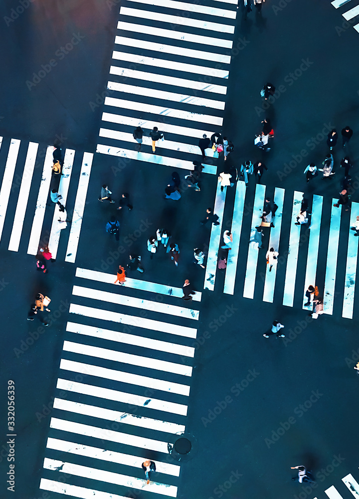 Aerial view of people crossing a big intersection in Ginza, Tokyo, Japan at night