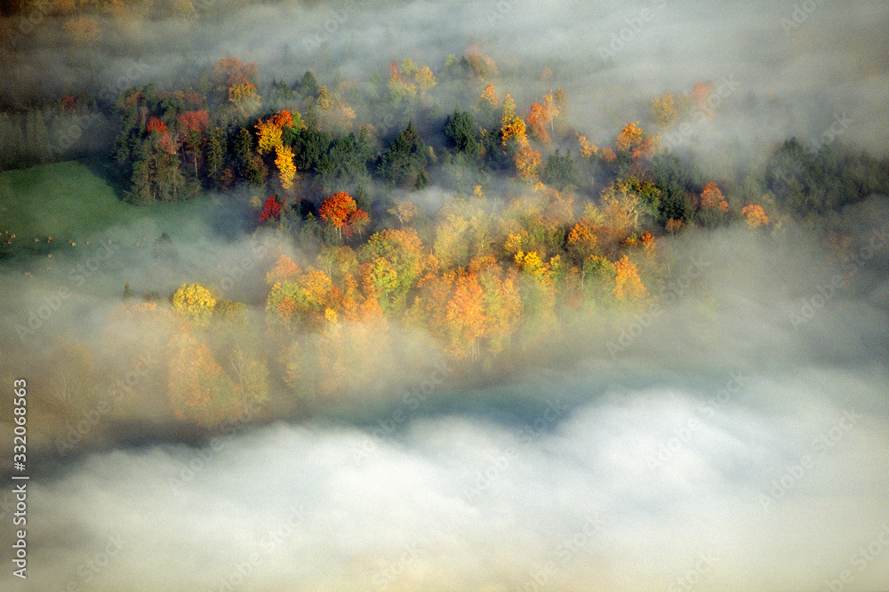 Aerial view of Morning fog and sunrise in autumn near Stowe, VT on Scenic Route 100