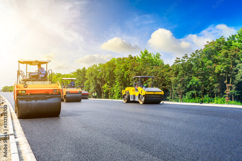 Construction site is laying new asphalt road pavement,road construction workers and road constructio