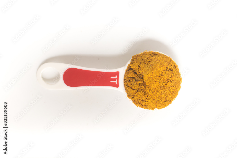 Curry Powder into a tablespoon. Measuring spoon