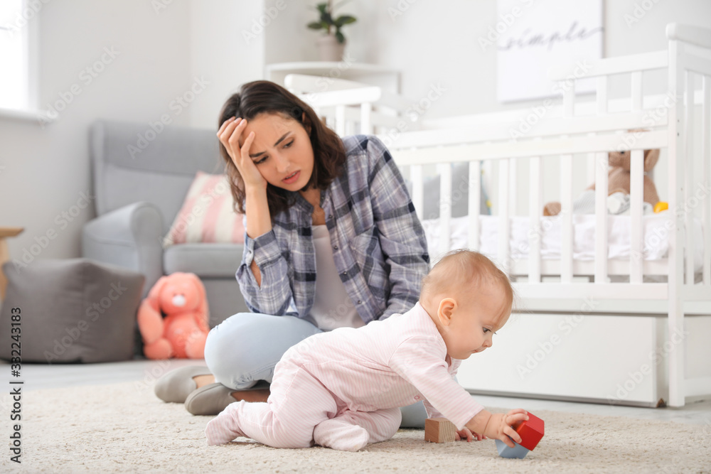 Young woman suffering from postnatal depression at home