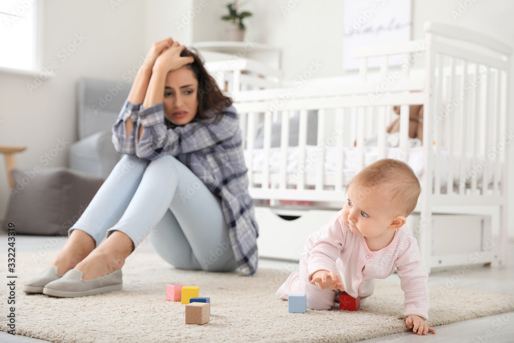 Young woman suffering from postnatal depression at home