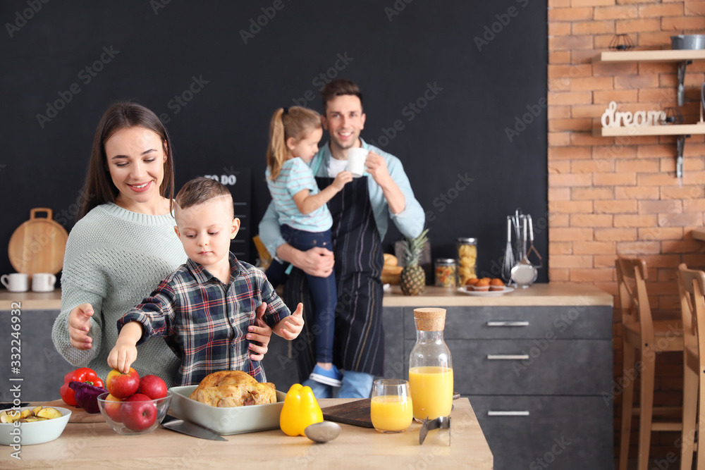 Mother with son cooking together in kitchen