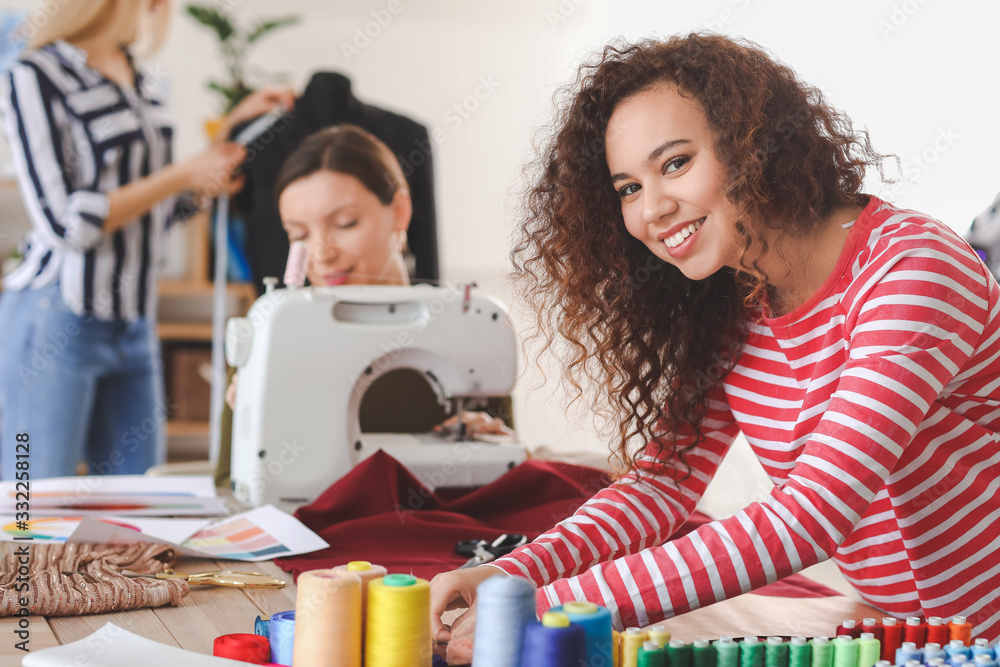 Young woman during tailors class in atelier