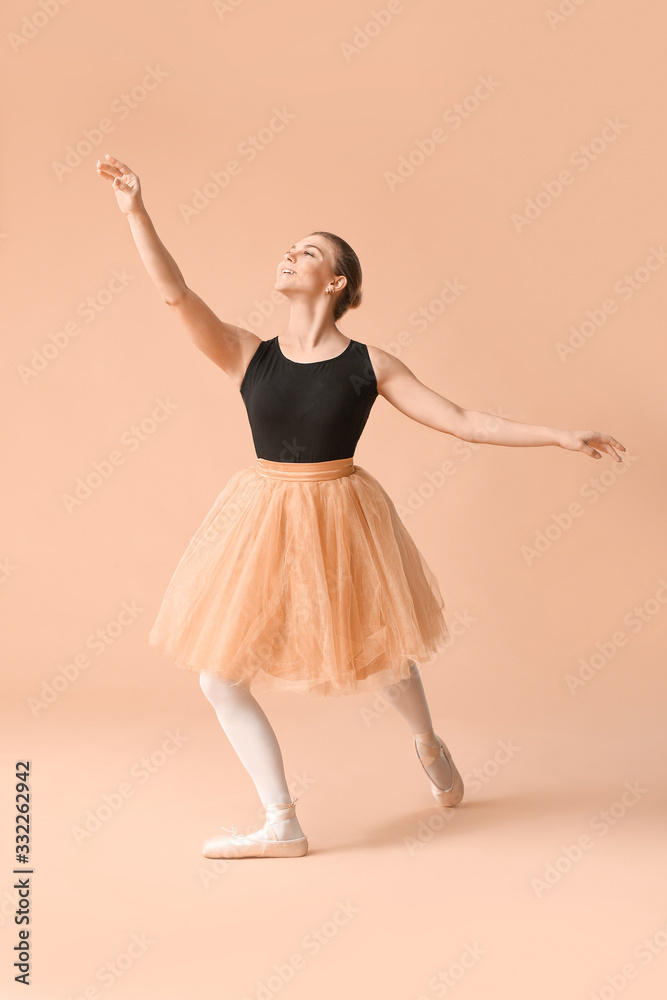 Beautiful young ballerina on color background