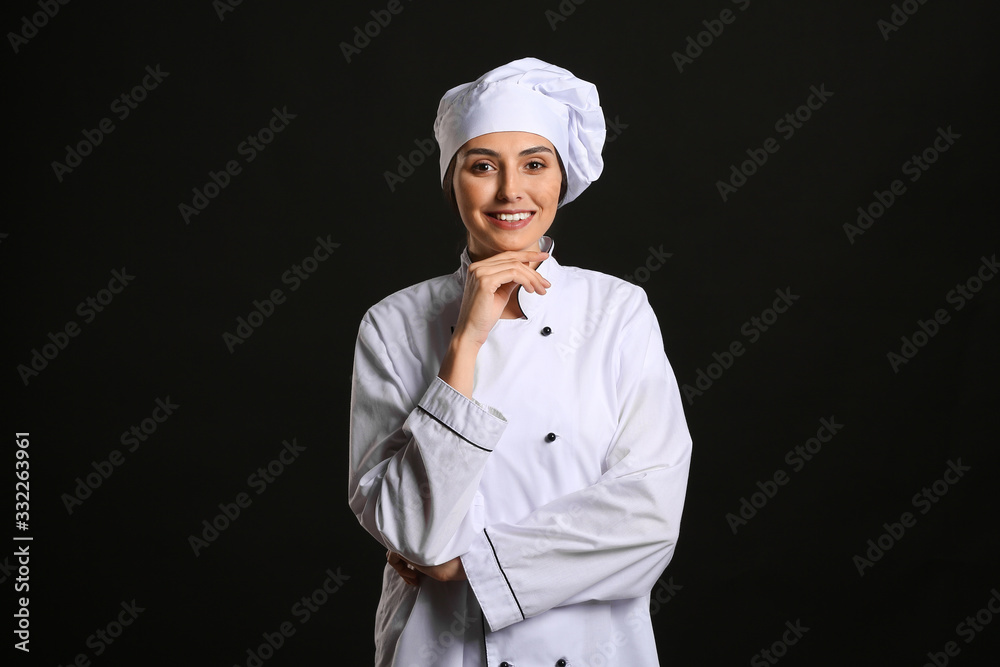 Portrait of female chef on dark background