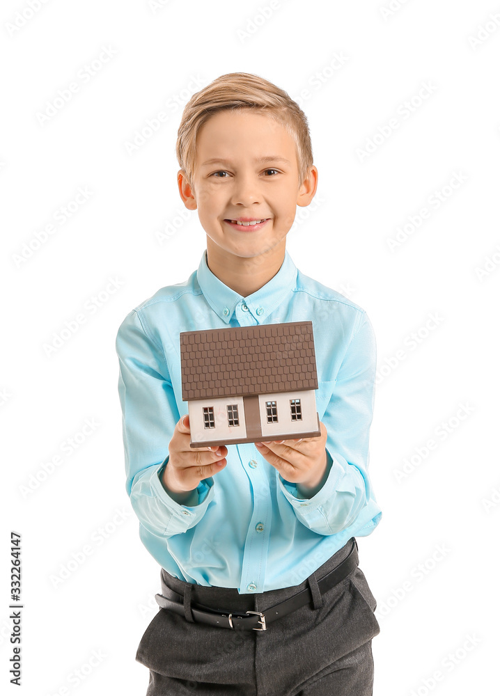 Portrait of little real estate agent with model of house on white background