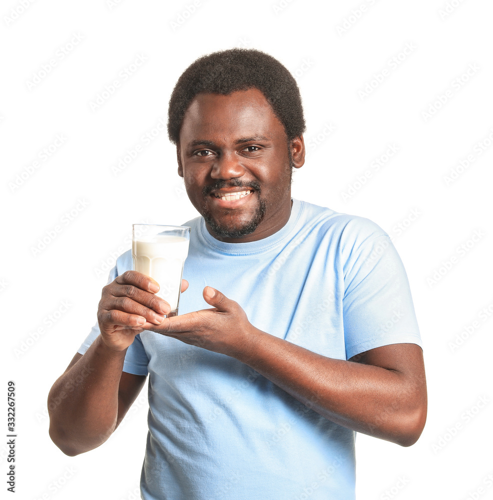 Young African-American man with milk on white background