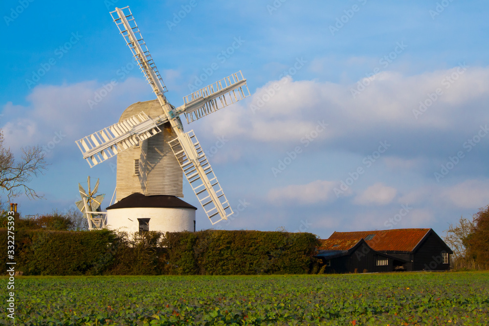 Windmill with farm and field