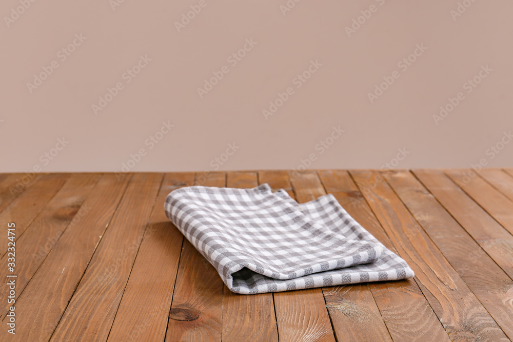 Napkin on table against color background