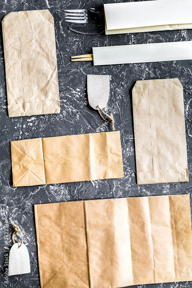 food delivery with paper bags and flatware gray background top view mockup