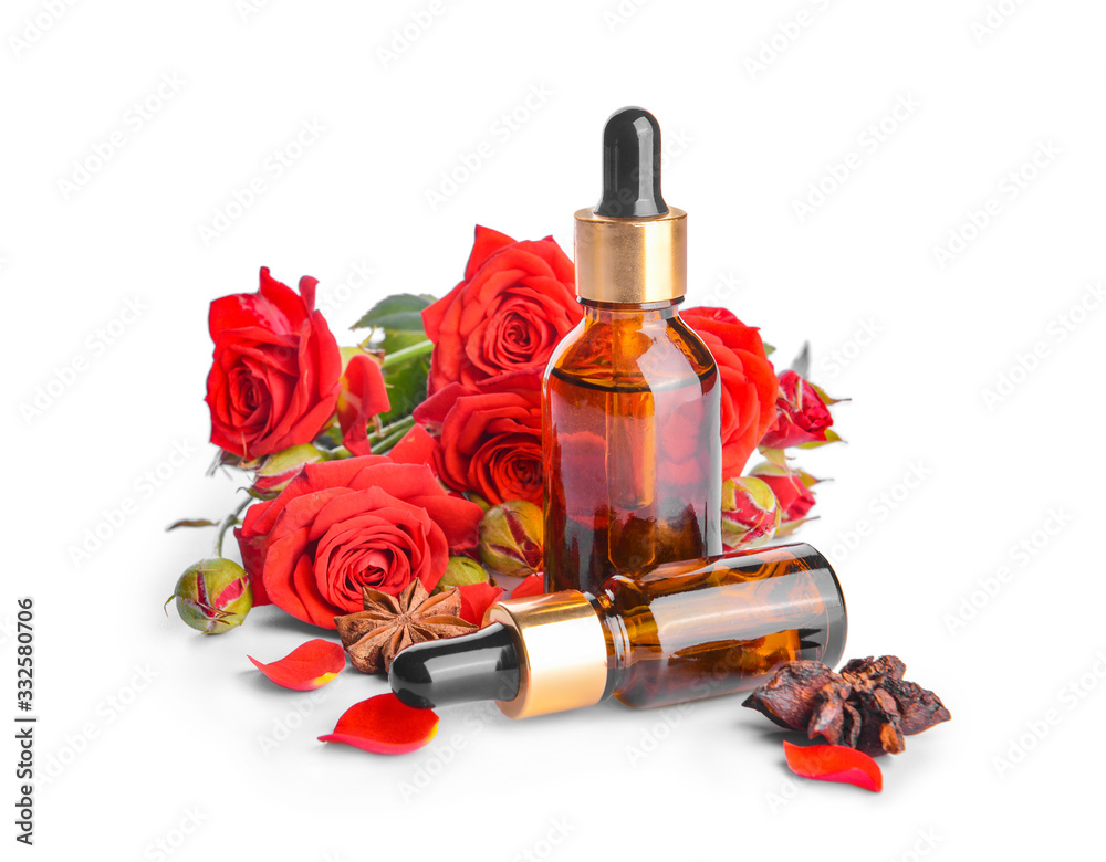 Bottles with rose essential oil on white background