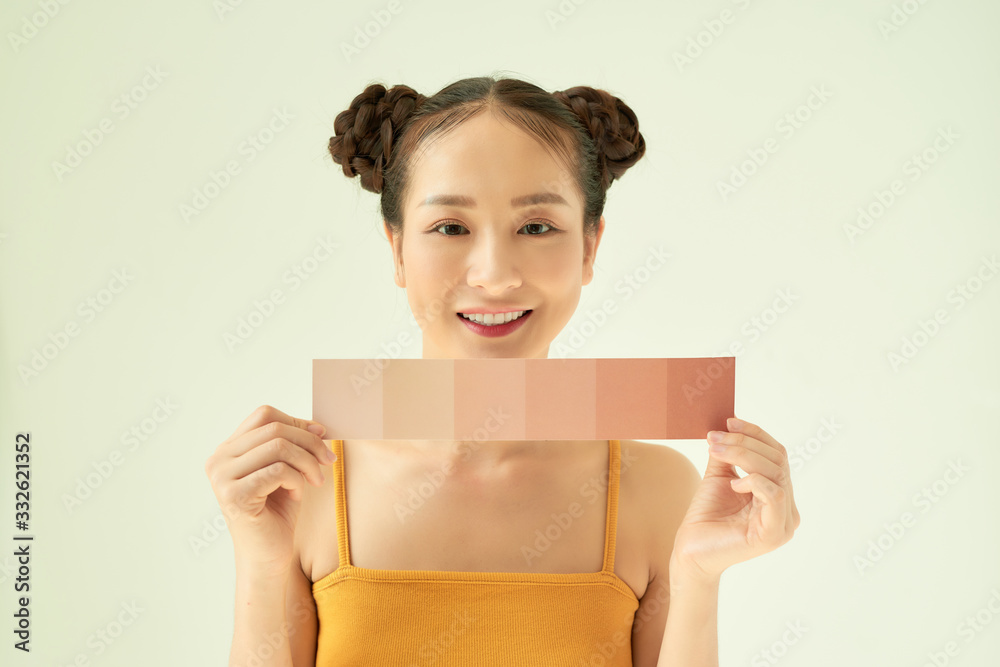 Hand of young happy female showing color palette over light background