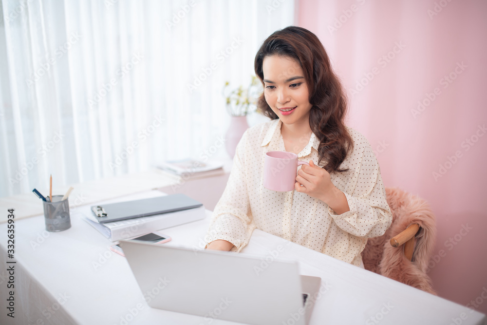 Protrait of Beautiful businesswoman sitting at desk and working with laptop computer.