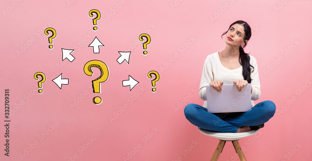 Big and small question marks with arrows with young woman using a laptop computer