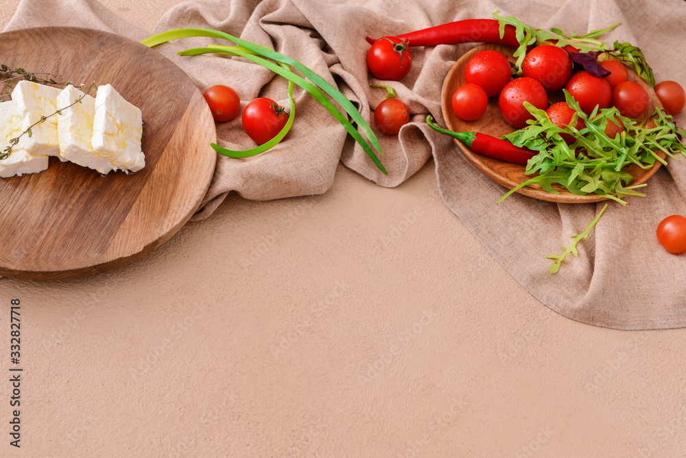 Tasty feta cheese with vegetables on color background