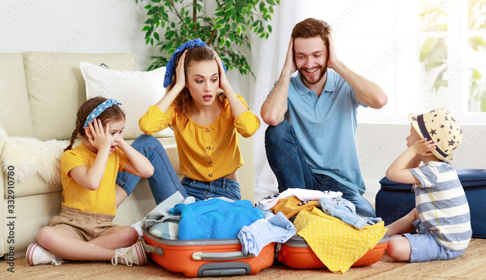 Happy family playing with suitcase preparing for vacation.