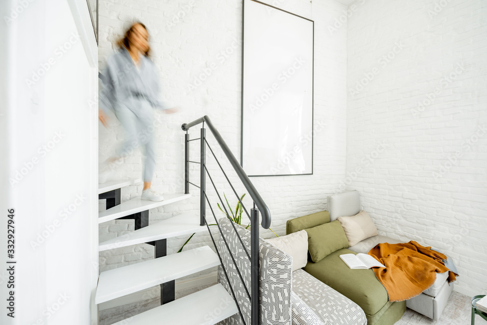 Interior view of the bright modern living room with a blurred in motion human figure