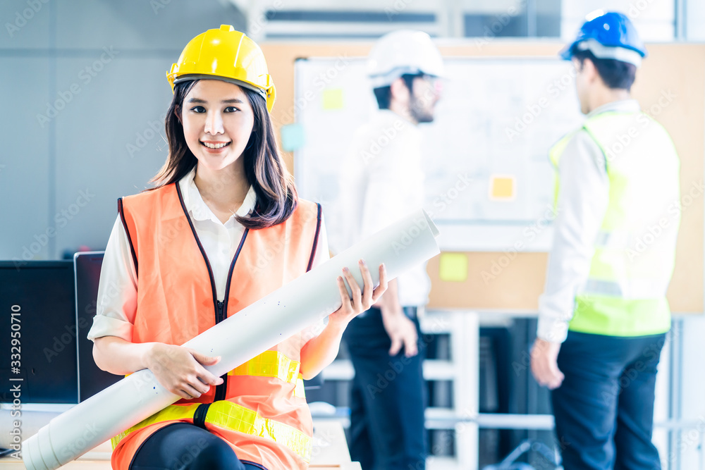 Asian young engineer group of home building member discuss for project planning. Smile woman hold bl