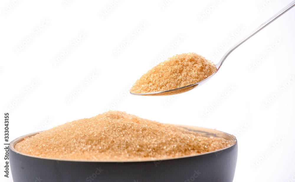 Brown sugar in a wooden bowl or wooden spoon Sugar for health Use for cooking or desserts on white a