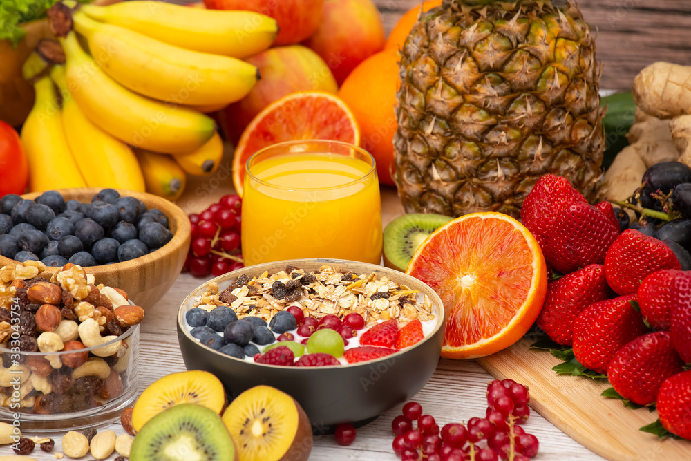 Group Fruits Breakfast mixed vegetables with salad bowl, nuts bowl, strawberry, banana, and pineappl