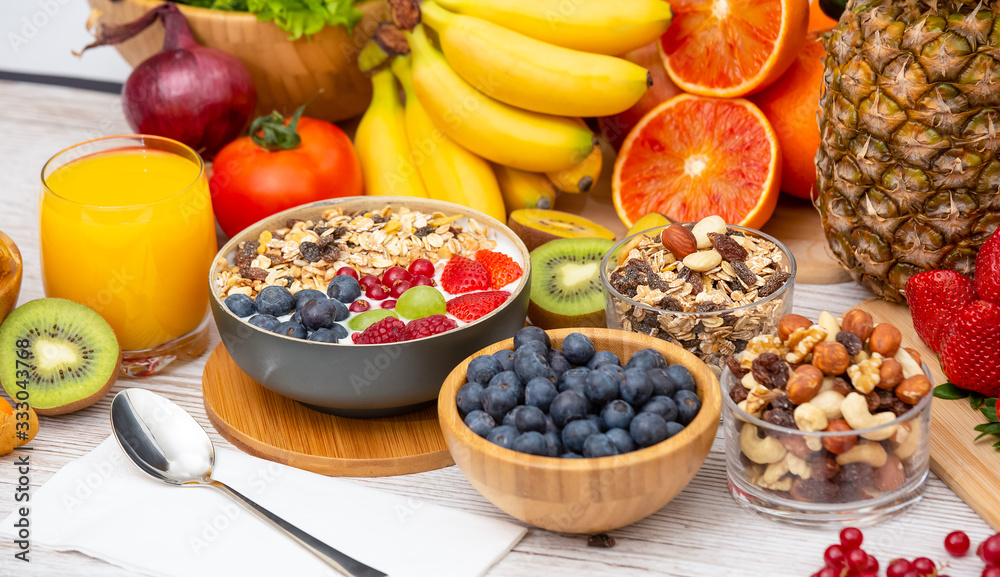 Group Fruits Breakfast mixed vegetables with salad bowl, nuts bowl, strawberry, banana, and pineappl