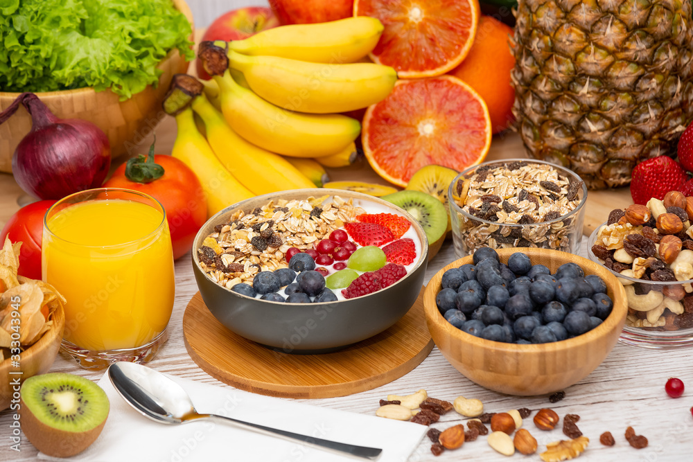 Group Fruits Breakfast mixed vegetables with salad bowl, nuts bowl, strawberry, banana, and pineappl