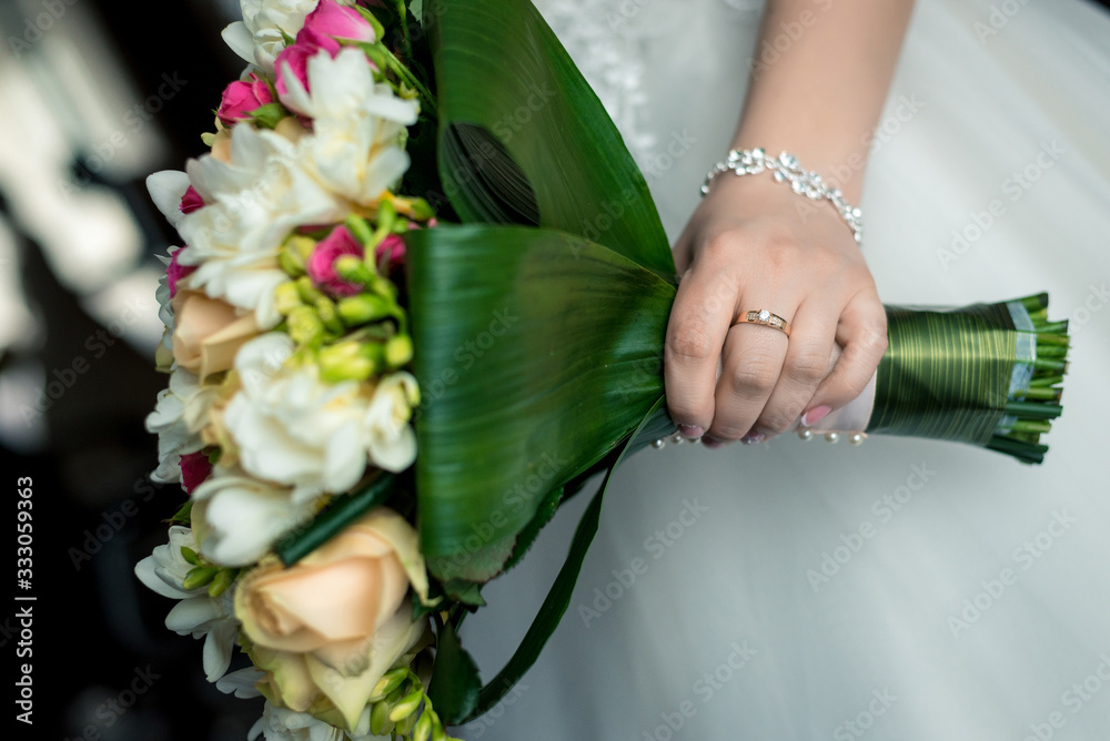 Beautiful wedding bouquet in the hand of the bride close-up