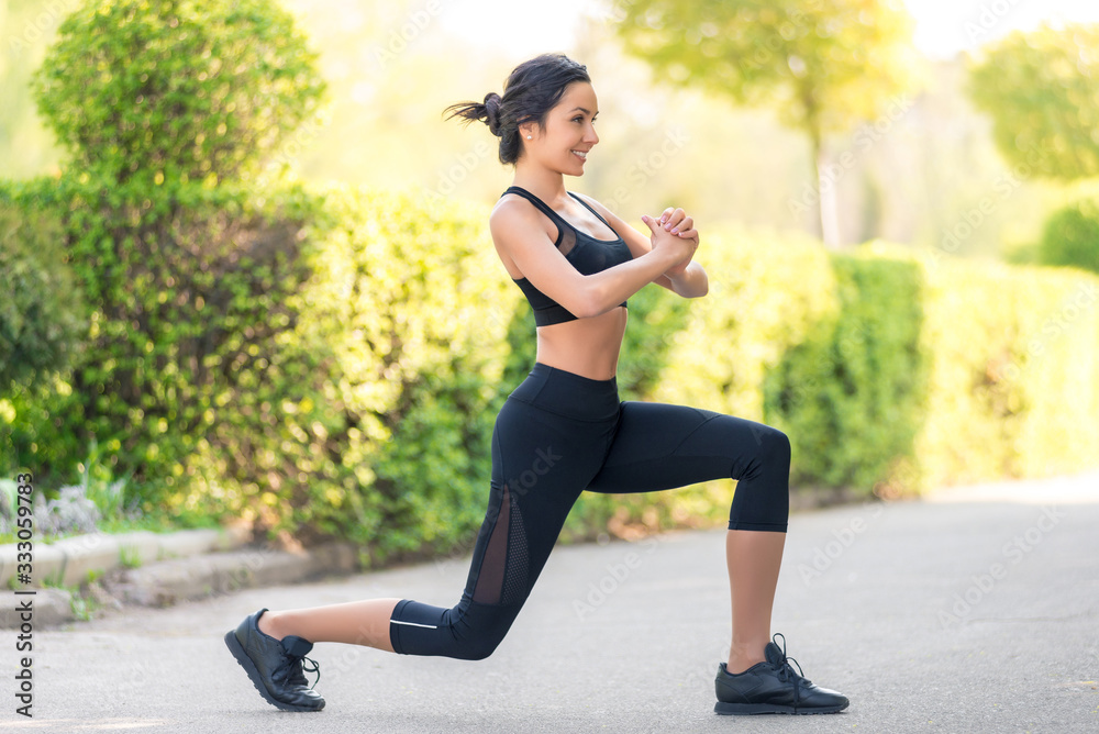 beautiful young woman with dark hair goes in for sports in nature.