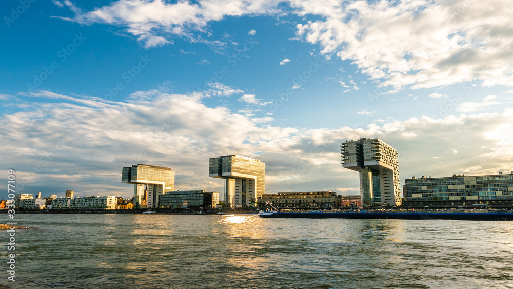 Panorama of crane houses by the Rhine under the blue sky and white clouds. Cityscape on sunny day