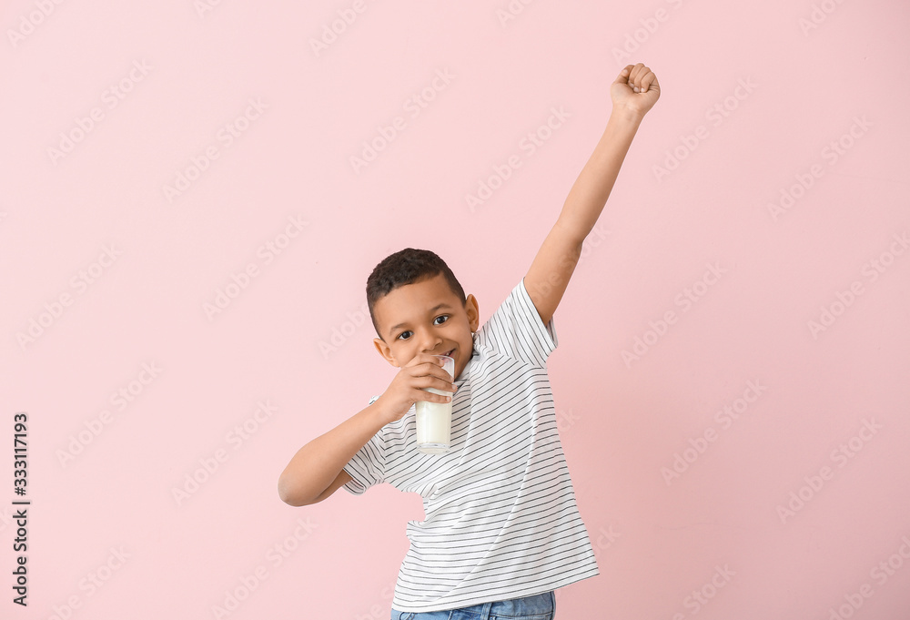 African-American boy with milk on color background