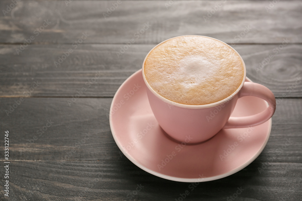 Cup of hot coffee on wooden table