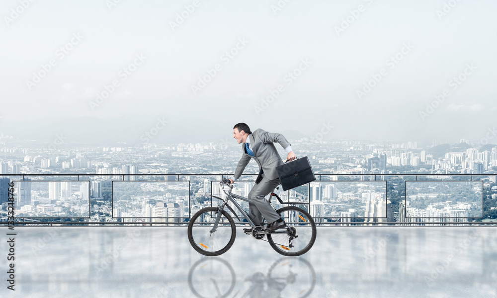 Man riding bicycle on penthouse balcony