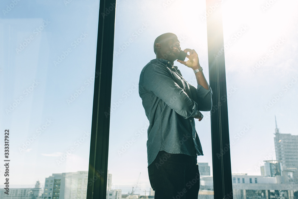 Businessman talking on cellphone in modern office