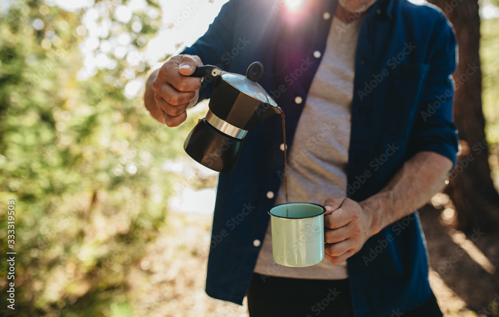 Man having coffee at camping site