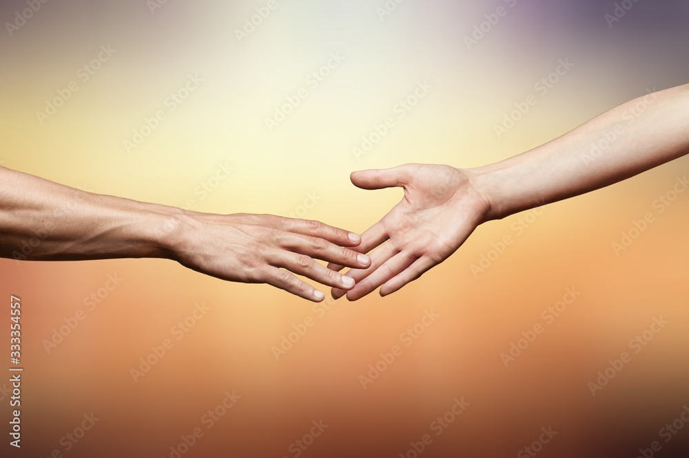 Hands of man and woman reaching to each other