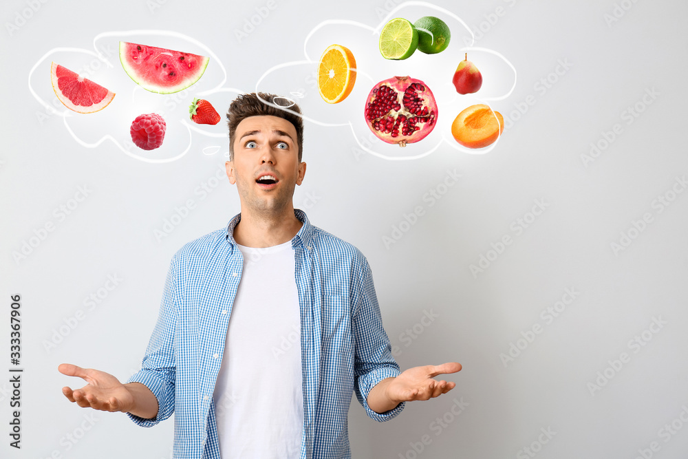 Excited young man on light background