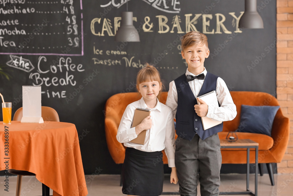 Cute little waiters in restaurant