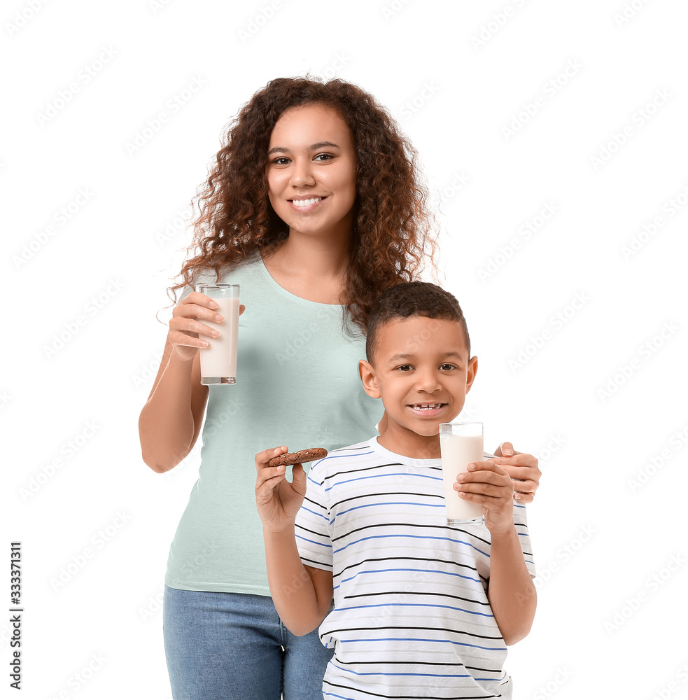 African-American boy and his mother with milk on white background