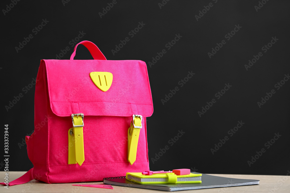 School backpack on table in classroom