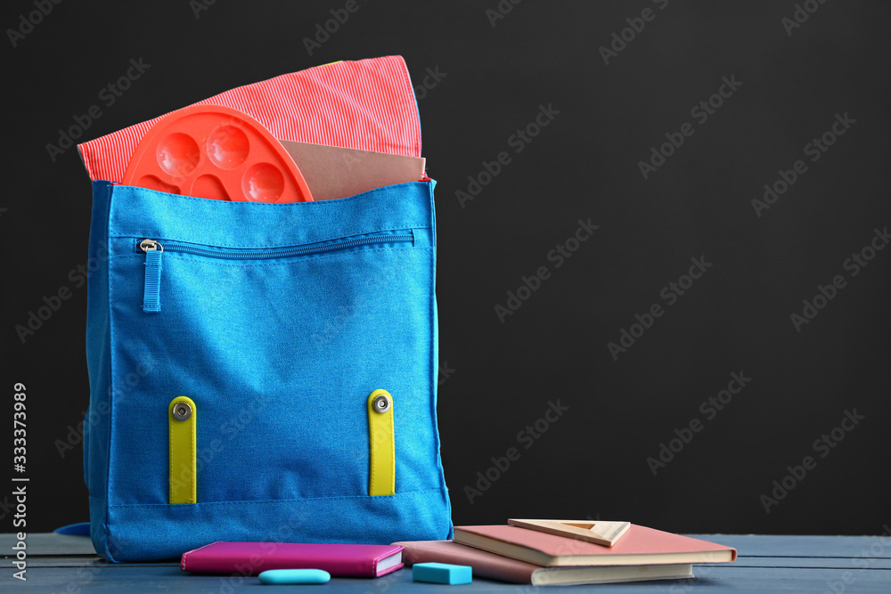 School backpack on table in classroom