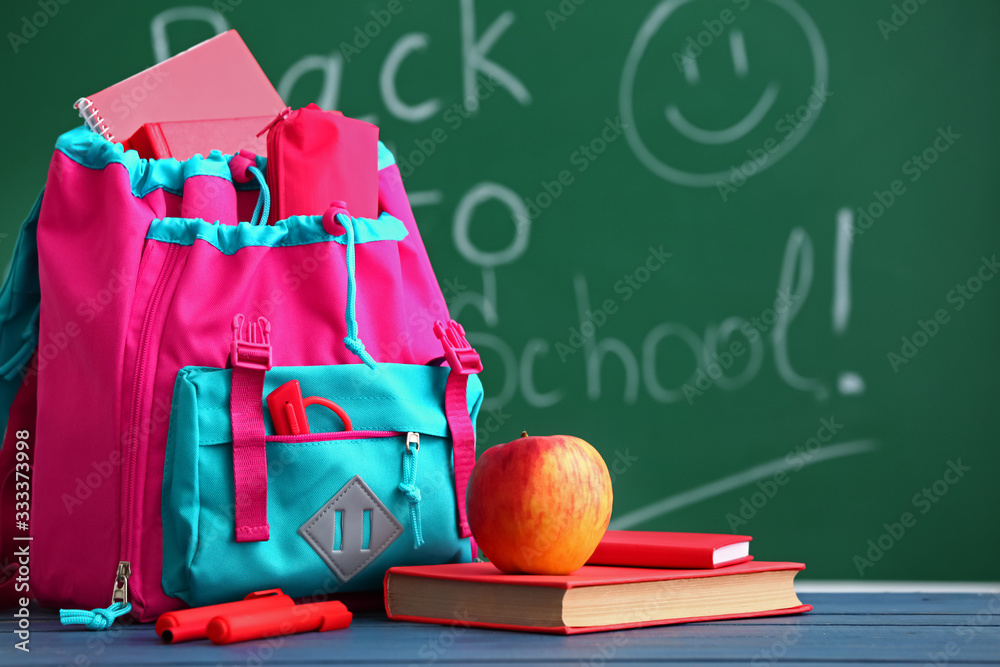 School backpack on table in classroom