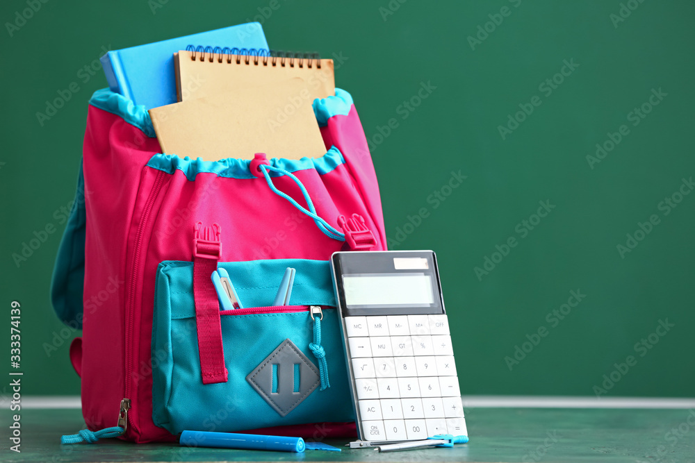 School backpack on table in classroom