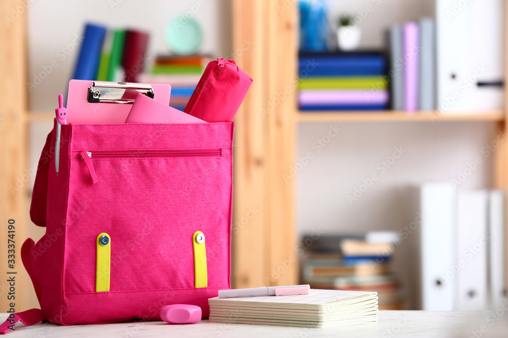 School backpack on table in classroom